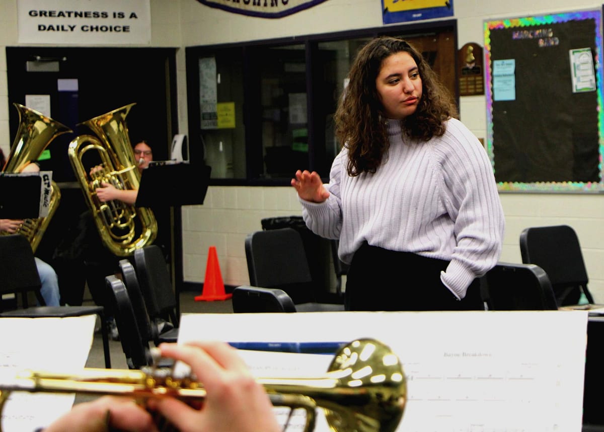 Miss Farmer conducts sectionals with the percussion and the brass.
