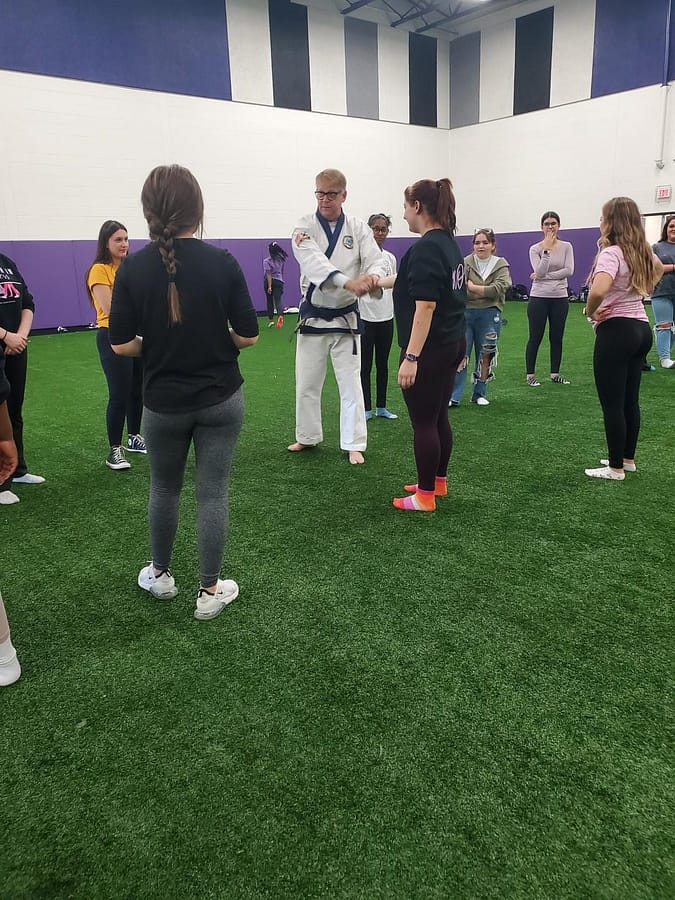 WOW members learn about escaping arm grabs with Mr. Brad, a coach from PKSA in Flat Rock during the self defense seminar. 