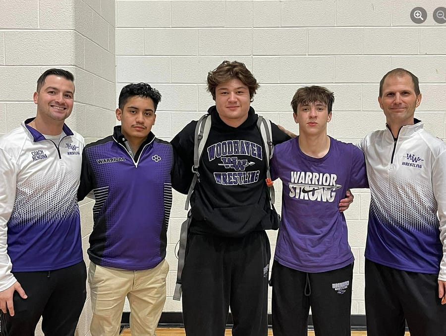 Marcello Luna stands proud with his fellow wrestling coaches and state-bound wrestlers Jake Navarro and Koen Huepenbecker at the close of regionals. 